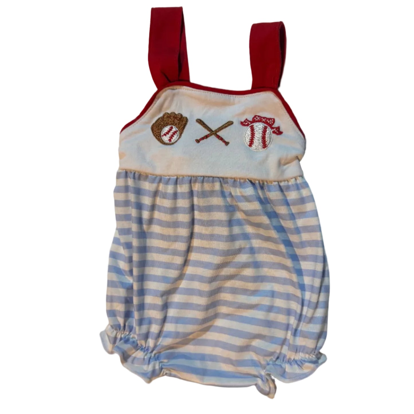 A baby romper or diaper cover laid flat on a beige towel. The garment has light blue and white horizontal stripes on the upper portion, a white lower panel with embroidered baseball-themed motifs (a red baseball, crossed bats, and a brown glove), and red ties at the bottom.