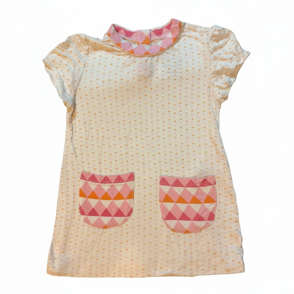 A handmade baby blanket or swaddle featuring a central panel with tiny pink and yellow dots, decorated with two pink and orange geometric arch shapes resembling eyes and a matching pink patterned patch at the bottom.