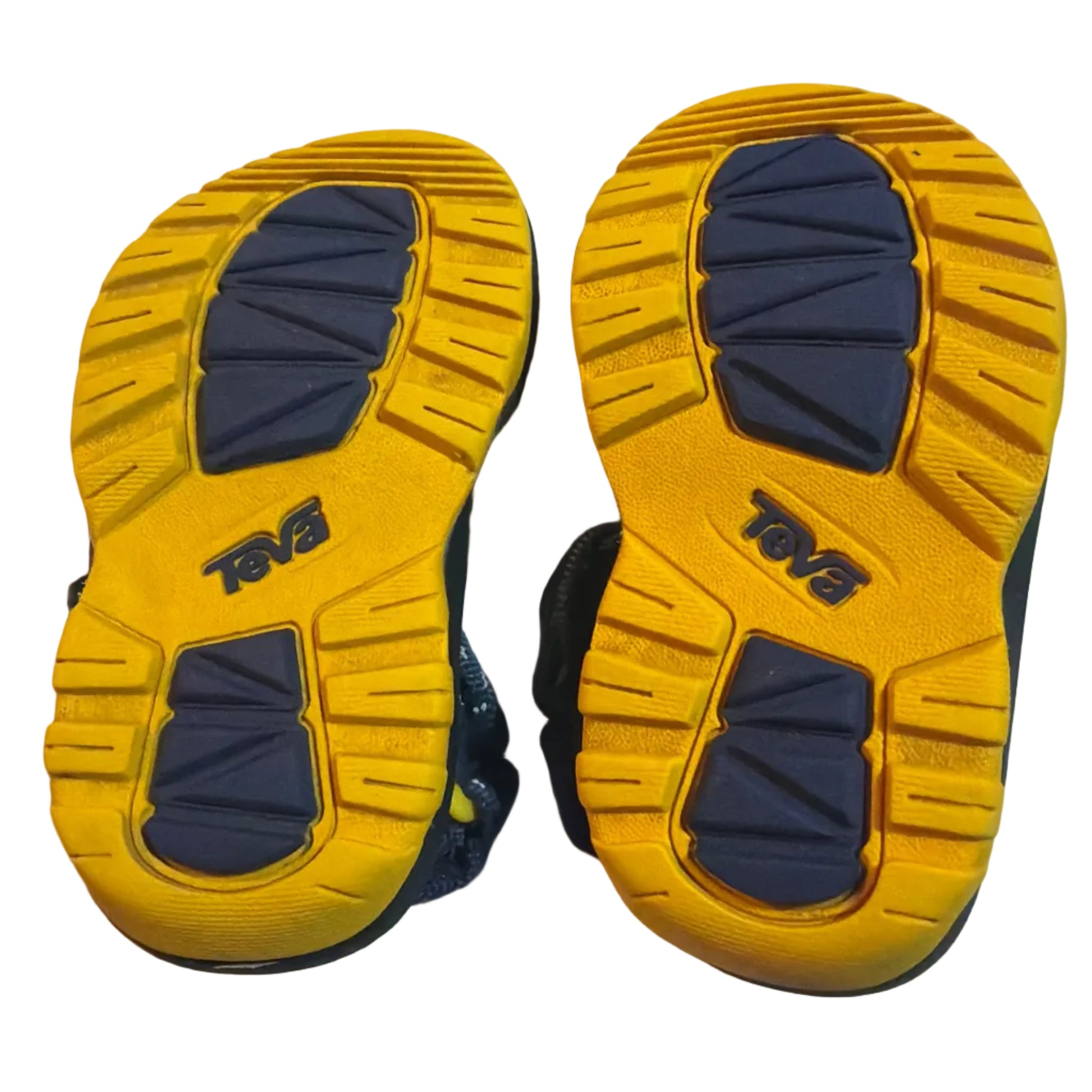 A pair of children's shoes shown from the bottom, displaying their yellow and navy blue treaded soles with the brand name 'TOG' visible.