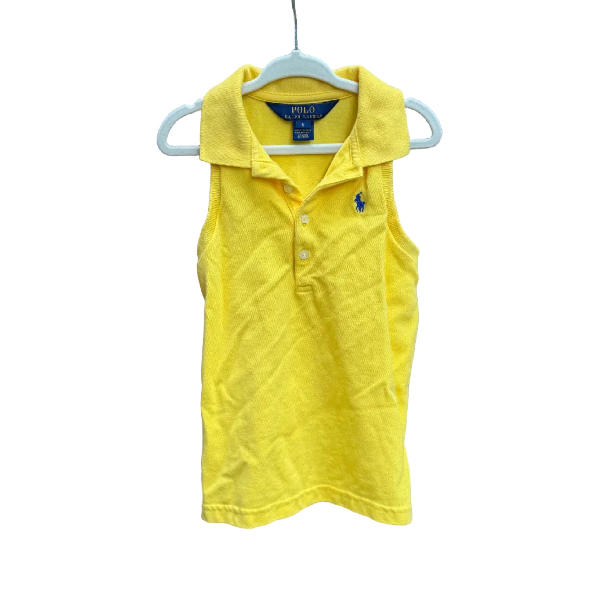 Yellow sleeveless polo shirt on a hanger against a brick wall with greenery in the background