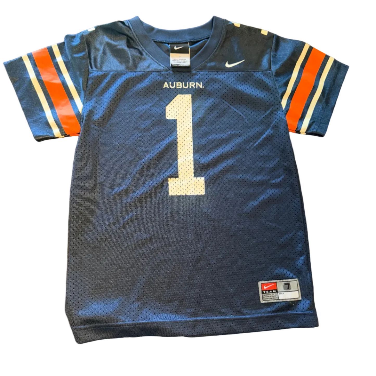 A navy blue Auburn Tigers football jersey with the number 1 on the front, laid flat on a wooden table. The jersey features orange and white sleeve stripes, 'AUBURN' and a white Nike swoosh on the chest, and a JHJ tag on the bottom right.