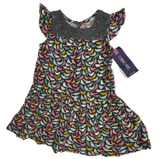 A toddler girl's tiered dress with a colorful banana print on a gray background, featuring a gray crochet yoke and flutter sleeves, with a purple Charokee brand tag attached.