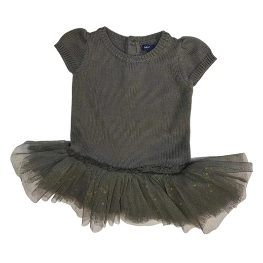 A toddler's short-sleeve knit top in a muted gray color, paired with a matching gray tulle tutu skirt featuring subtle gold glitter accents, laid flat on a white background.