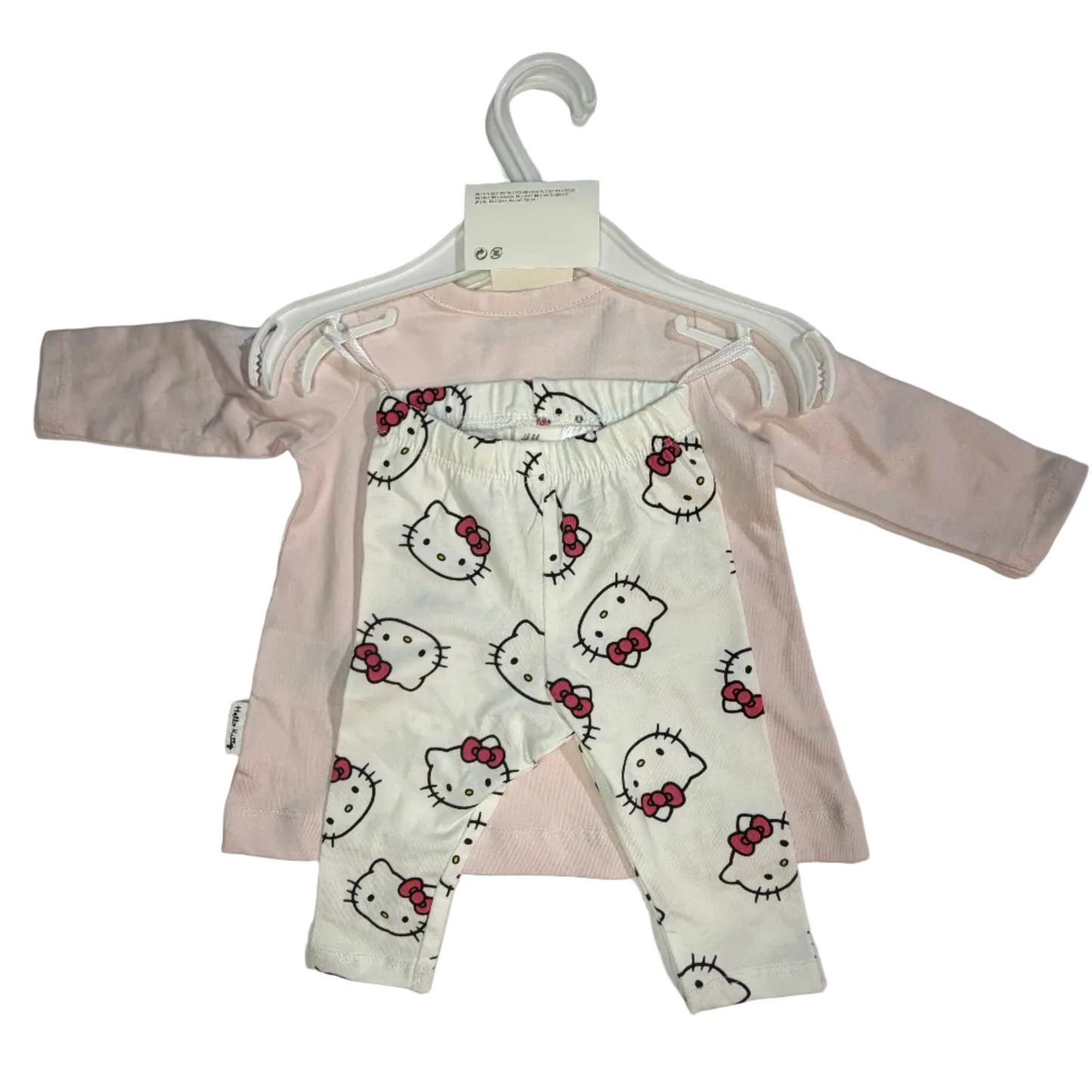 Baby long-sleeve romper set on a white hanger, featuring a white and pink Hello Kitty patterned front with a solid light pink back panel.
